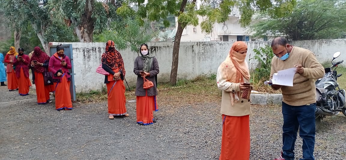 Health department workers outside the hospital waiting for their turn during the dry run at Mandsaur on Friday