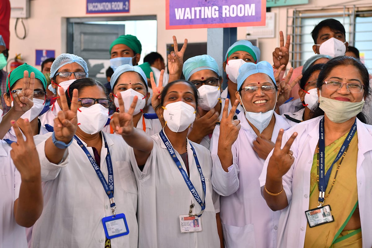 Doctors of the Rajawadi Hospital make the victory sign as they wait for the start of the Covid-19 coronavirus vaccination drive in Mumbai on January 16, 2021.
