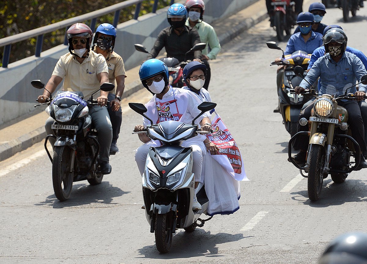 Banerjee was seen sitting behind state minister Firhad Hakim, who rode the battery-powered electric scooter