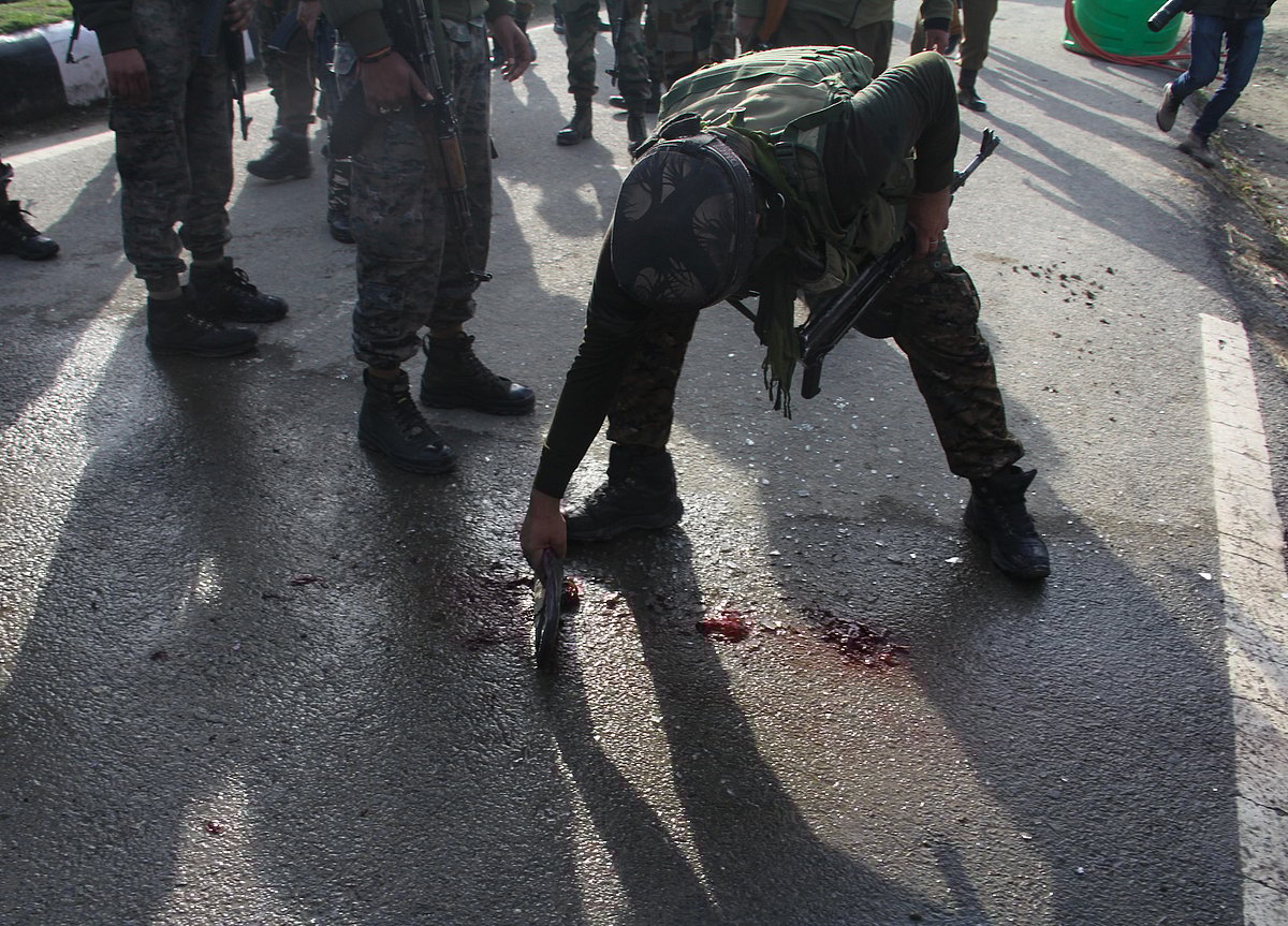 CRPF personnel cleanes the blood stains after suspected militants attack on security forces at Lawaypora on the outskirts of Srinagar.