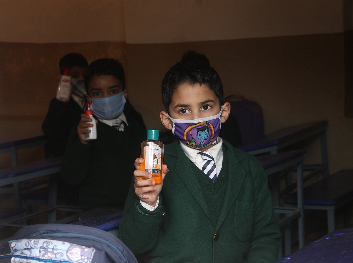 Students of junior wing attending classes on the first day of school as they reopen after almost a year, at Srinagar, kashmir.