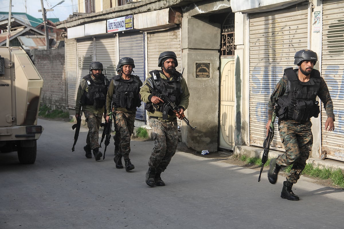 paramilitary troopers are seen near the site of an attack by suspected militants on Lawaypora national highway, on the outskirts of Srinagar.