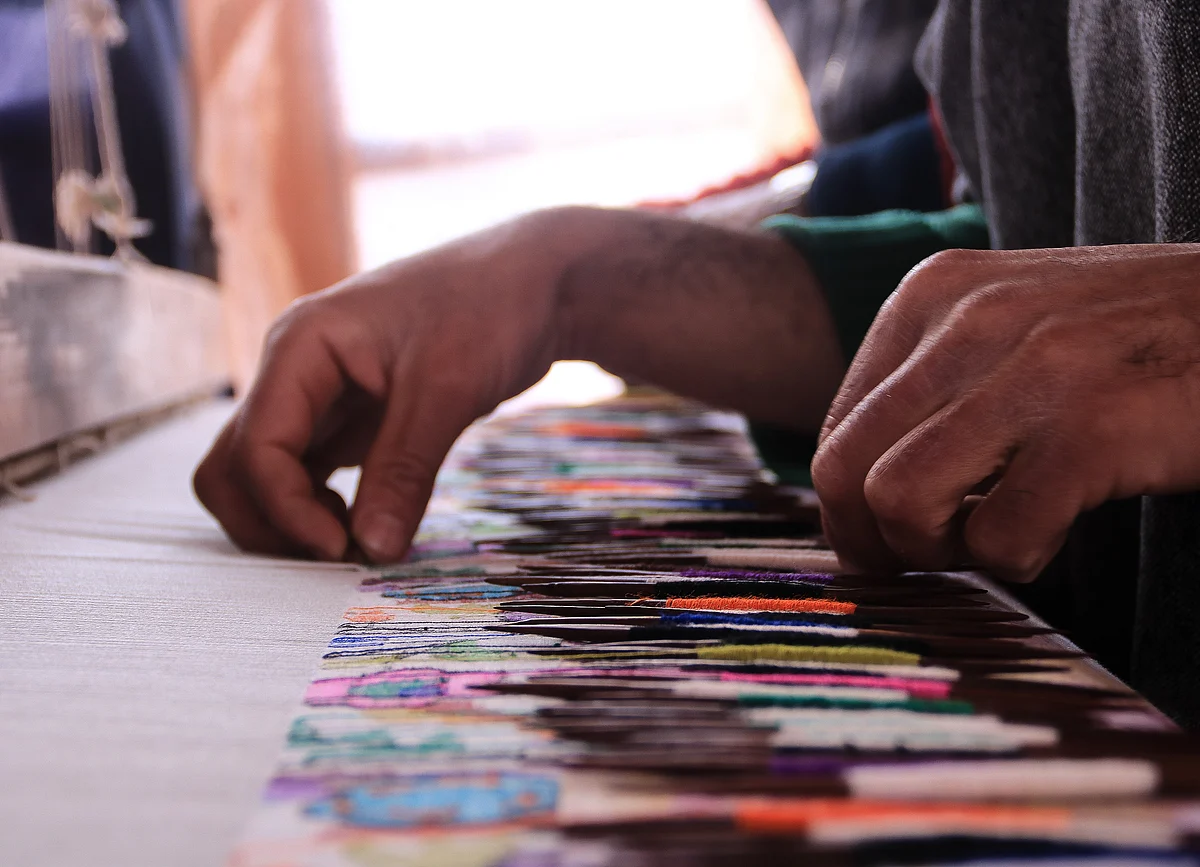 Kashmiri artisan works at the loom to make a Kani Shawl at a village in Budgam district, in the west of Srinagar city.