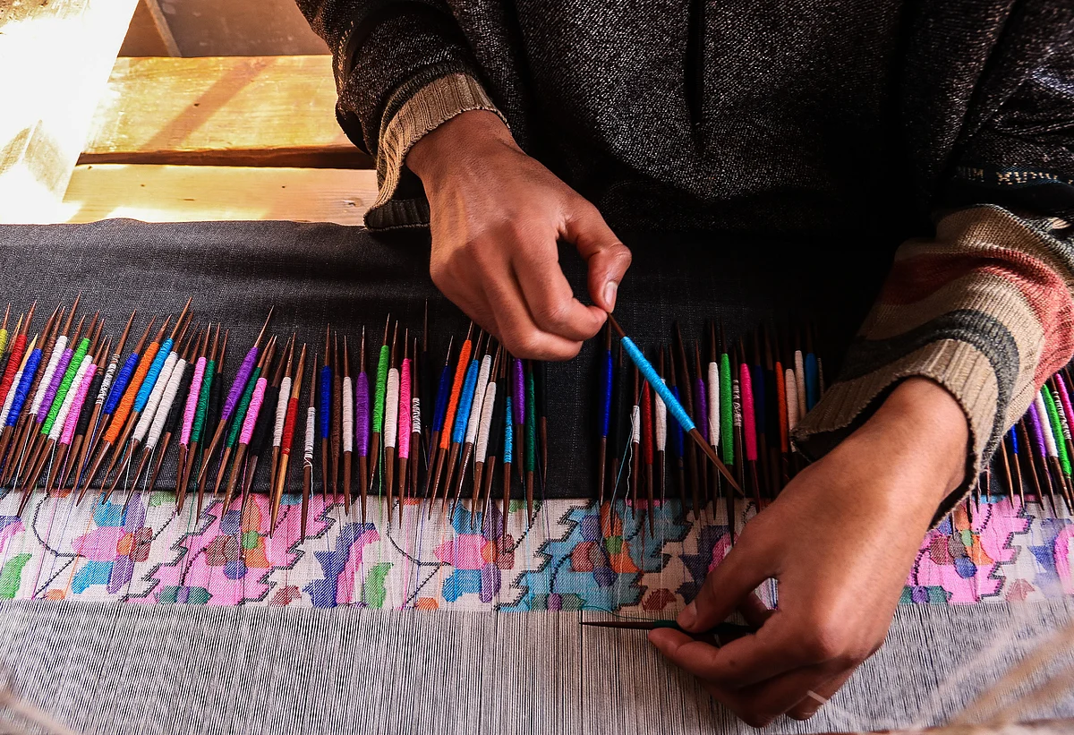 Kashmiri artisan works at the loom to make a Kani Shawl at a village in Budgam district, in the west of Srinagar city.