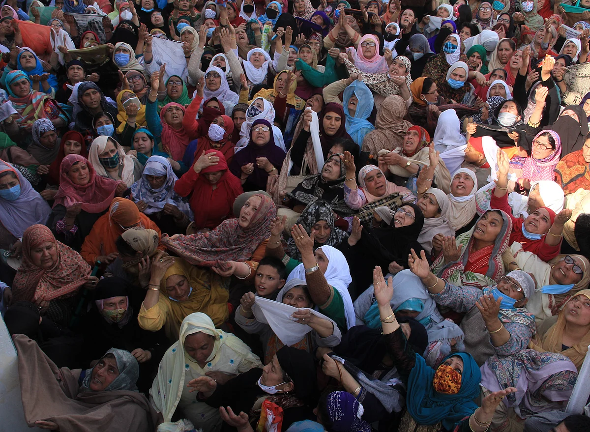 Kashmiri Muslim women react upon seeing a relic believed to be a hair from the beard of Prophet Mohammed, being displayed on Friday following Meeraj-un-Nabi, a festival which marks the ascension of Prophet Mohammed to Heaven, at the Hazratbal shrine in Srinagar.