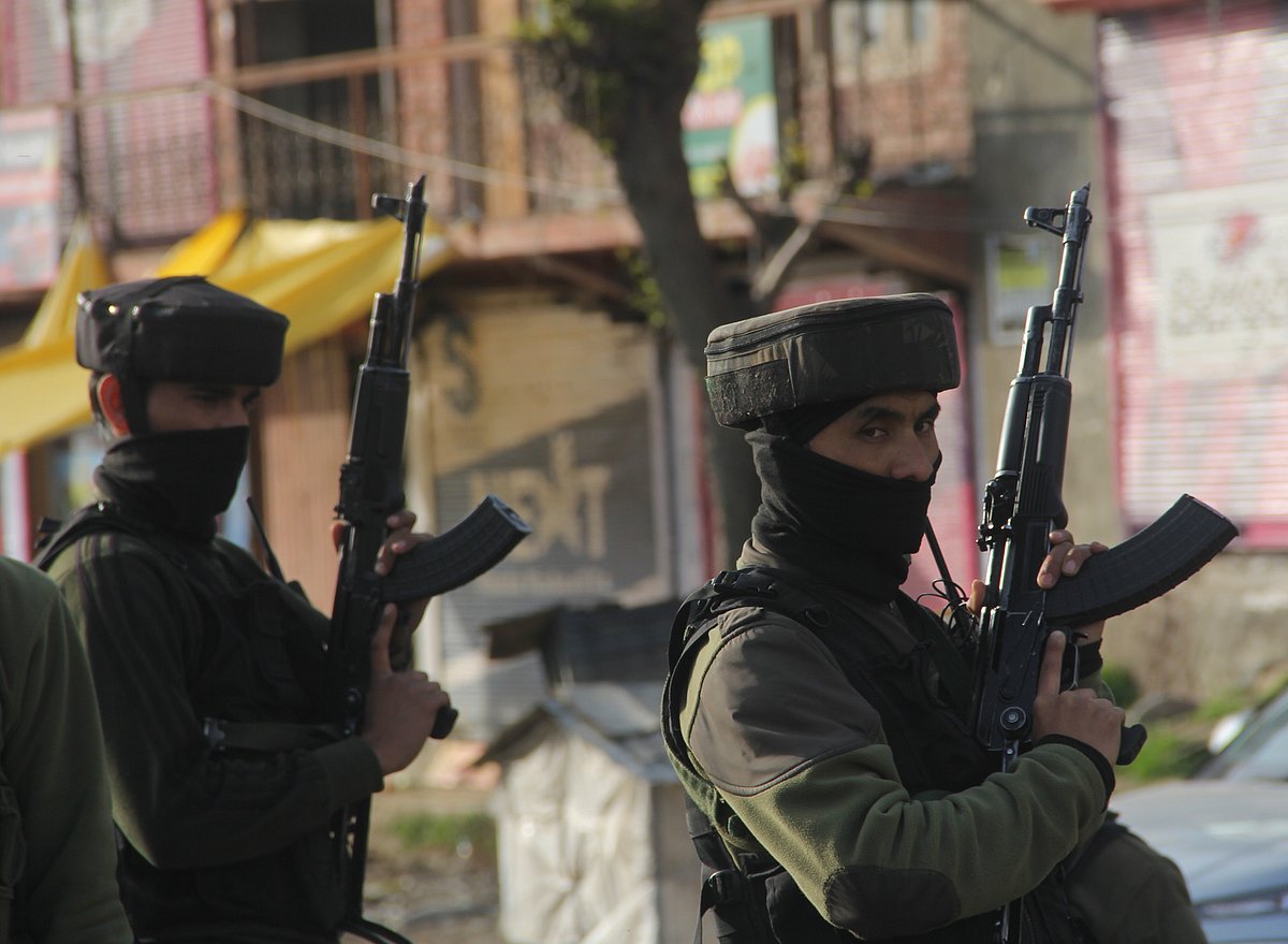 Security personnel stand guard at the spot after a militant attack, in Lawaypora on the outskirts of Srinagar.
