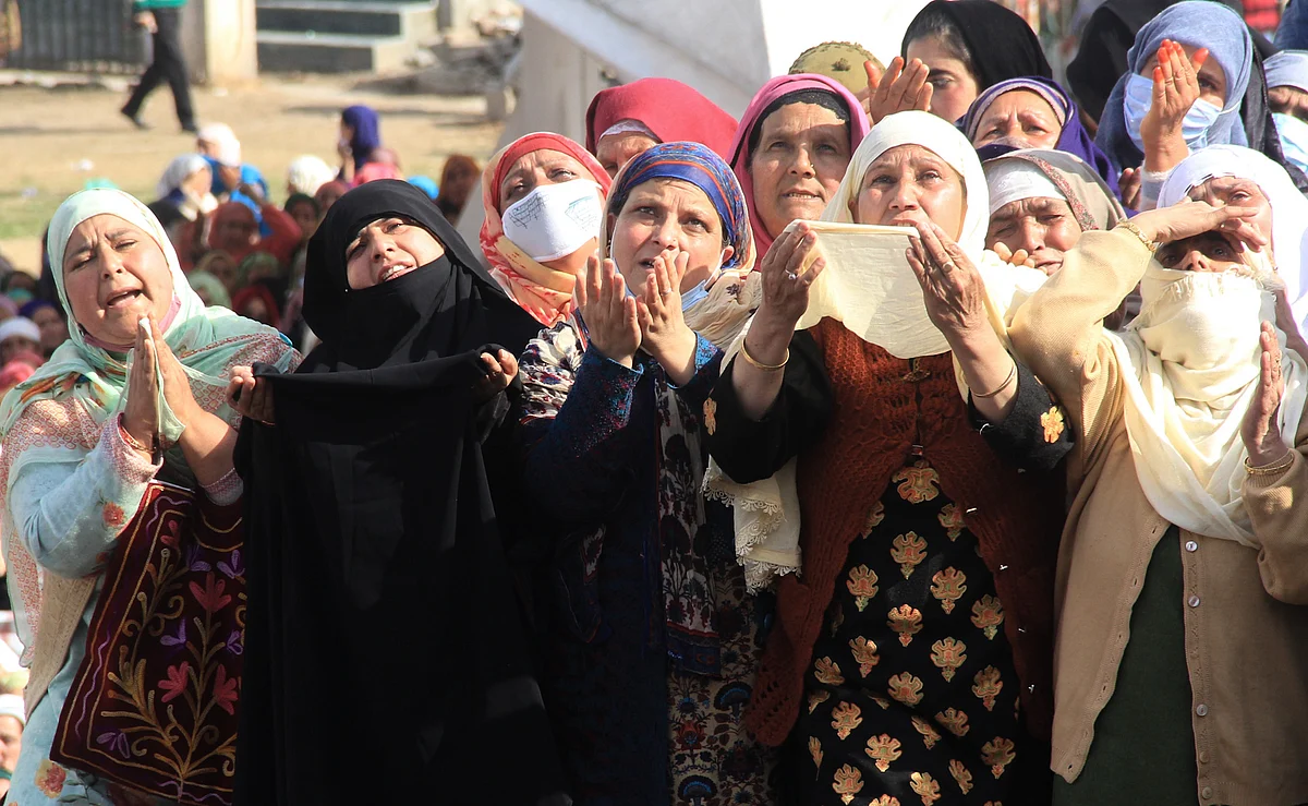 Kashmiri Muslim women react upon seeing a relic believed to be a hair from the beard of Prophet Mohammed, being displayed on Friday following Meeraj-un-Nabi, a festival which marks the ascension of Prophet Mohammed to Heaven, at the Hazratbal shrine in Srinagar.