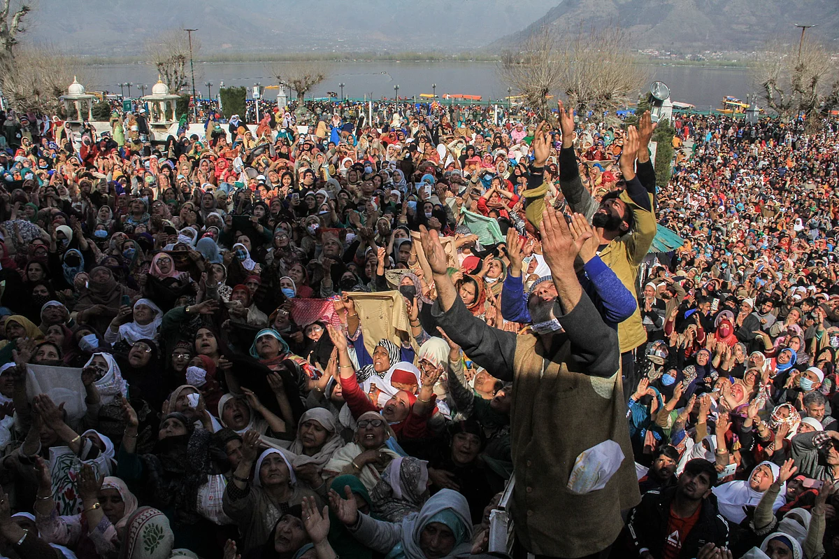 Kashmiri Muslims react upon seeing a relic believed to be a hair from the beard of Prophet Mohammed, being displayed on Friday following Meeraj-un-Nabi, a festival which marks the ascension of Prophet Mohammed to Heaven, at the Hazratbal shrine in Srinagar.