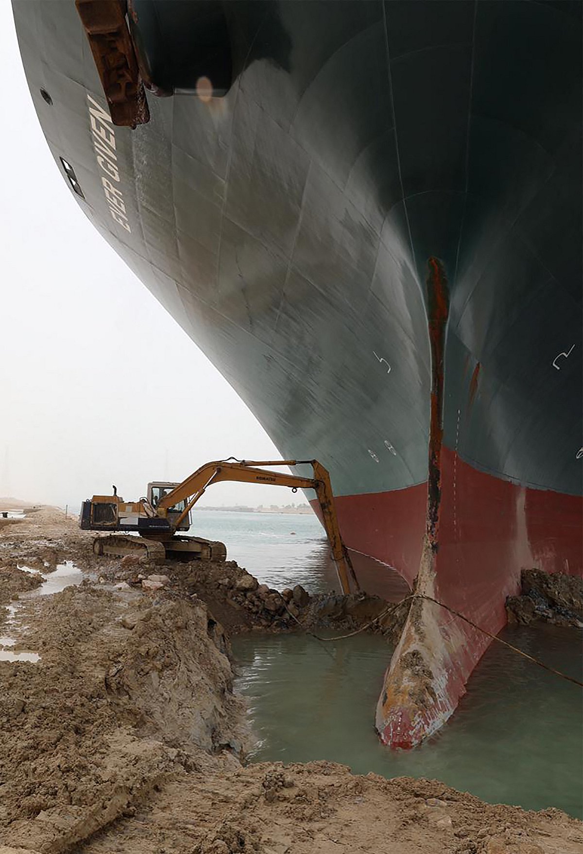 A handout picture released by the Suez Canal Authority on March 25, 2021 shows the Taiwan-owned MV Ever Given lodged sideways and impeding all traffic across the waterway