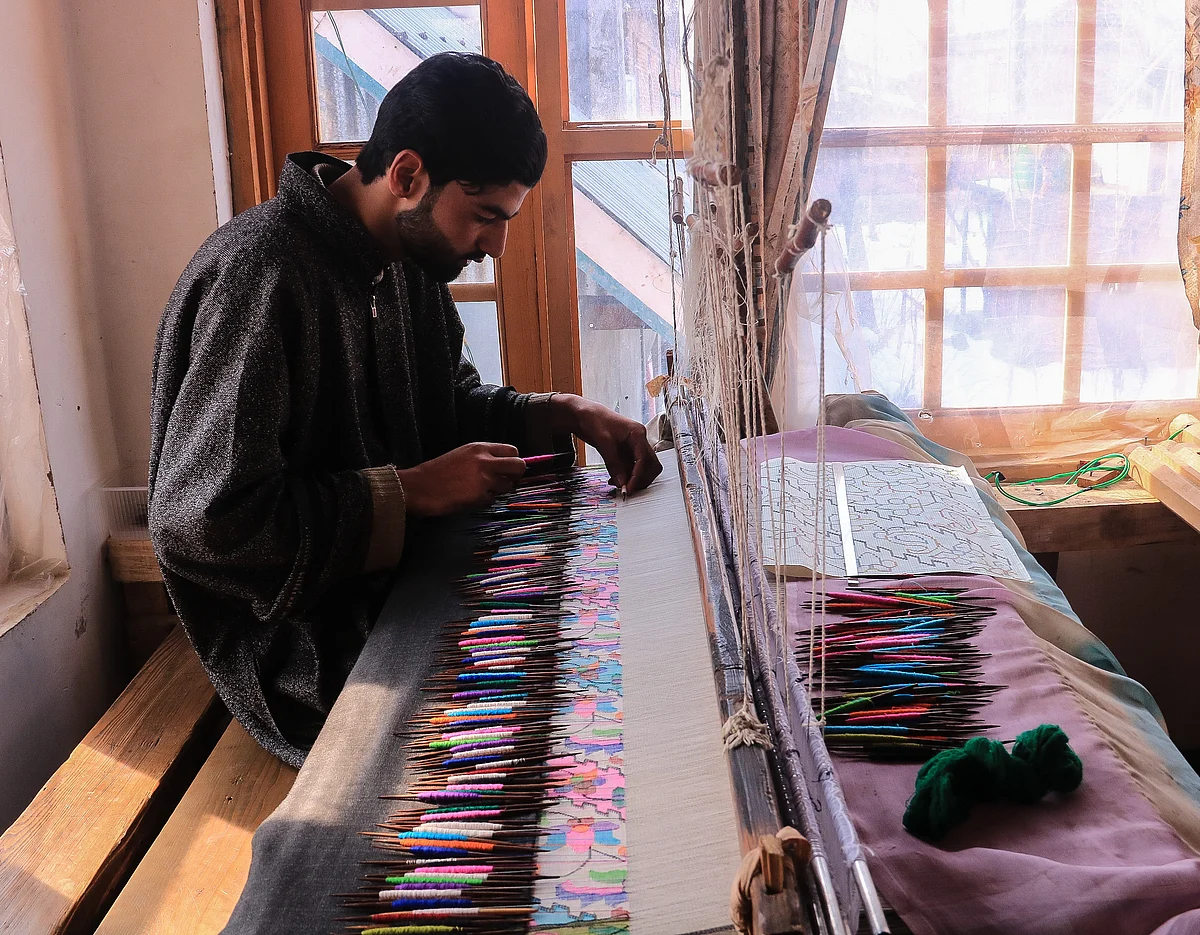 Kashmiri artisan works at the loom to make a Kani Shawl at a village in Budgam district, in the west of Srinagar city.
