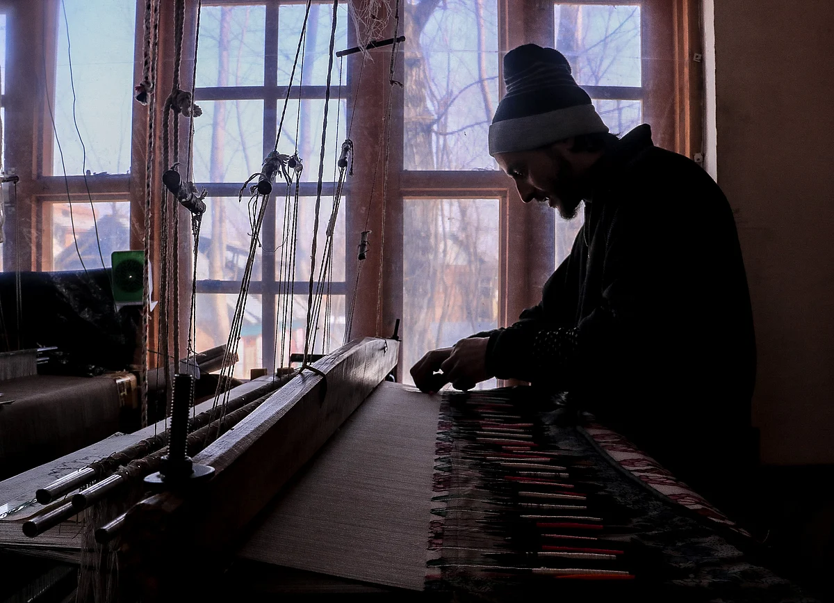 Kashmiri artisan works at the loom to make a Kani Shawl at a village in Budgam district, in the west of Srinagar city.