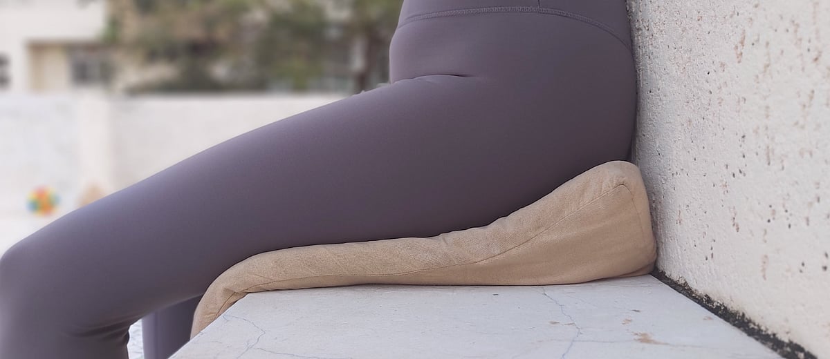 Seated Triangular Cushion: Six inches at the hip tapering down to one inch at the thighs.