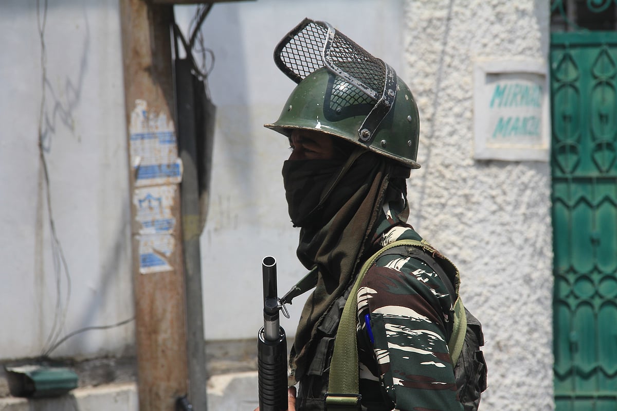 Securitymen stand guard outside Mirwaiz Manzil during strict restrictions imposed in downtown, Srinagar on the death anniversaries of two senior separatist leaders, Mirwaiz Moulvi Farooq and Abdul Ghani Lone on May 21, 2021.