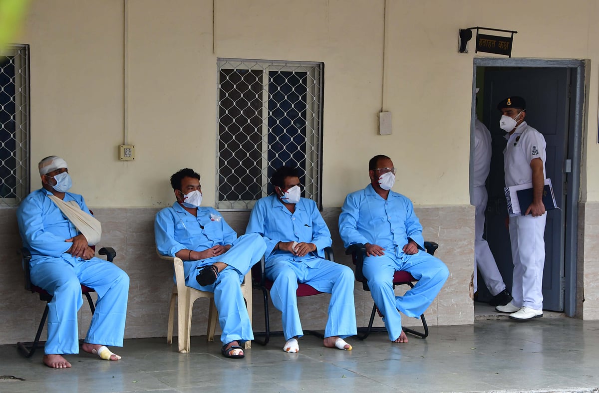 Rescued crew members of barge Gal Construction being brought at INS Shikra in Mumbai on Tuesday