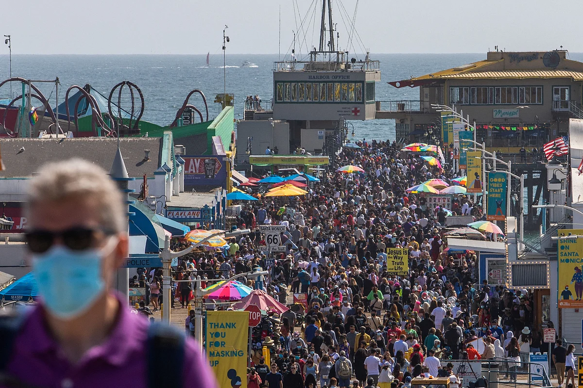 eople walk through the Santa Monica pier ahead of Memorial Day in Santa Monica, California on May 29, 2021.