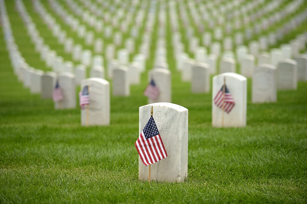 American flags are pictured in front of graves ahead of Memorial Day in the Los Angeles National Cemetery in Los Angeles, California on May 29, 2021.