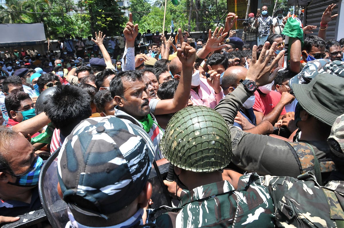  A local leader tries to control TMC workers gathered outside the CBI office Nizam Palace in protest over the arrest of party ministers and MLAs in connection with the Narada scam case, in Kolkata, Monday,