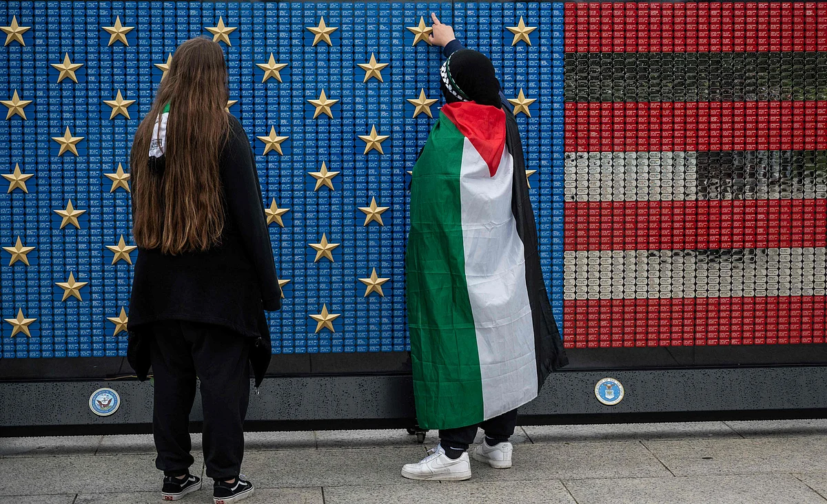 Supporters of Palestine look a Memorial Day installation as other demonstrators hold a pro-Palestine rally at the Lincoln Memorial in Washington, DC on May 29, 2021.