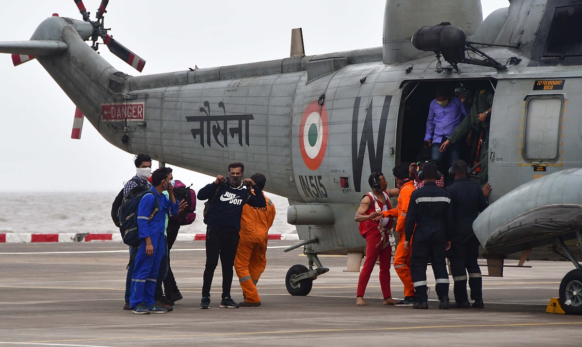 Rescued crew members of barge Gal Construction being brought at INS Shikra in Mumbai on Tuesday