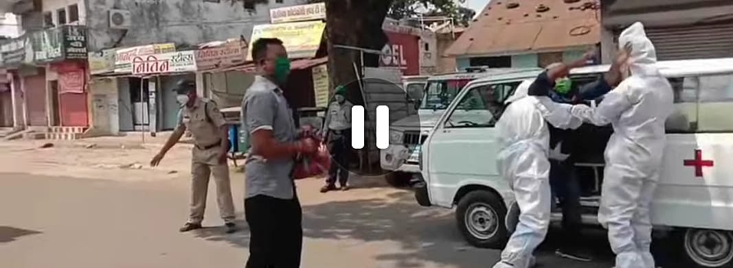 Police (dressed in PPE kits) bundle a youth loiterer into an ambulance in Mandla town of Madhya Pradesh on Monday.