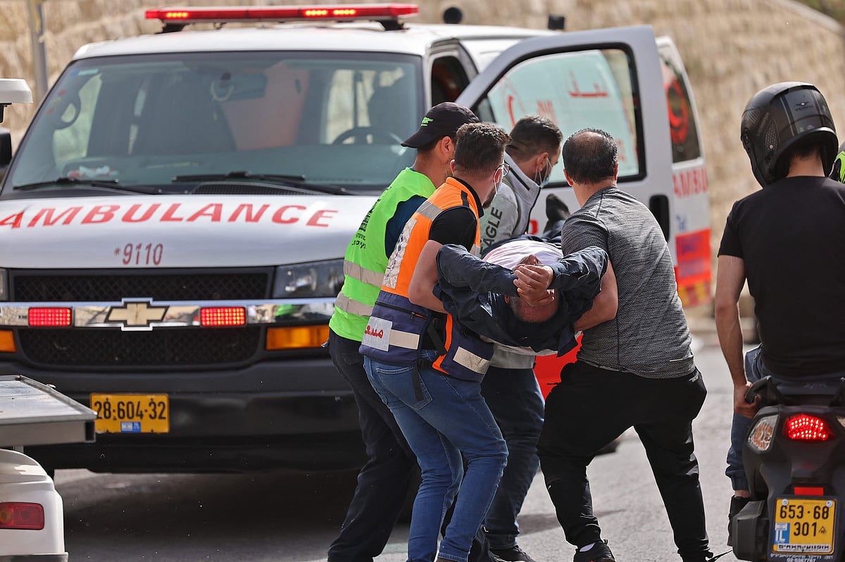 Palestinian medics evacuate a wounded protester amid clashes with Israeli security forces in Jerusalems Old City on May 10, 2021, ahead of a planned march to commemorate Israels takeover of Jerusalem in the 1967 Six-Day War.