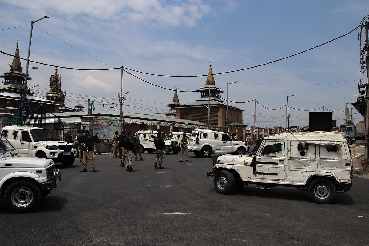 Security men stand guard on a deserted street during corona curfew in Srinagar, Kashmir. As the COVID-19 cases continue to rise the authorities imposed strict Corona curfew across Jammu and Kashmir in order to stop further spread of Coronavirus.