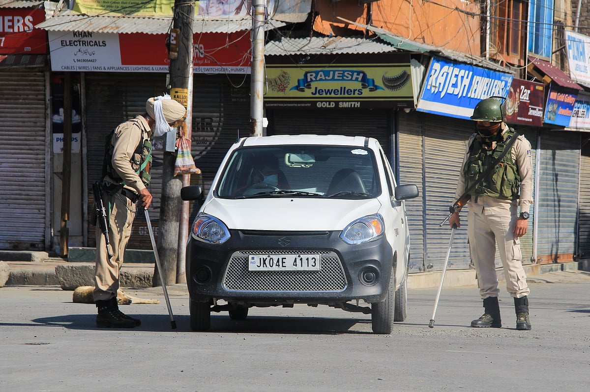 Securitymen stop a car on a street during Corona curfew in Srinagar, Kashmir. As the COVID-19 cases continue to rise the authorities imposed strict Corona curfew across Jammu and Kashmir in order to stop further spread of Coronavirus.