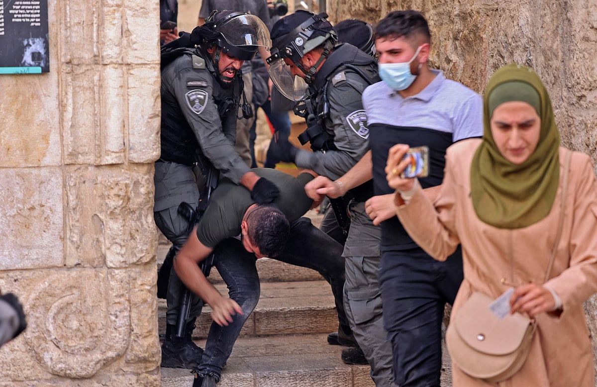 Israeli security forces detain a Palestinian protester amid clashes in Jerusalems Old City on May 10, 2021, ahead of a planned march to commemorate Israels takeover of Jerusalem in the 1967 Six-Day War.