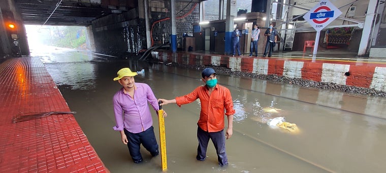 Railway workers at waterlogged Sion station