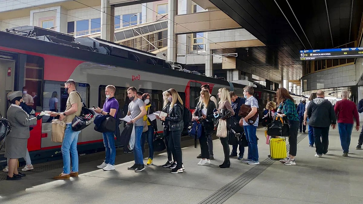 Passengers at a railway station in Minsk, Belarus, stand in line to board a high-speed train to Moscow on May 28. Many people who want to leave Belarus to avoid the growing repression under authoritarian President Alexander Lukashenko now find themselves increasingly cornered.