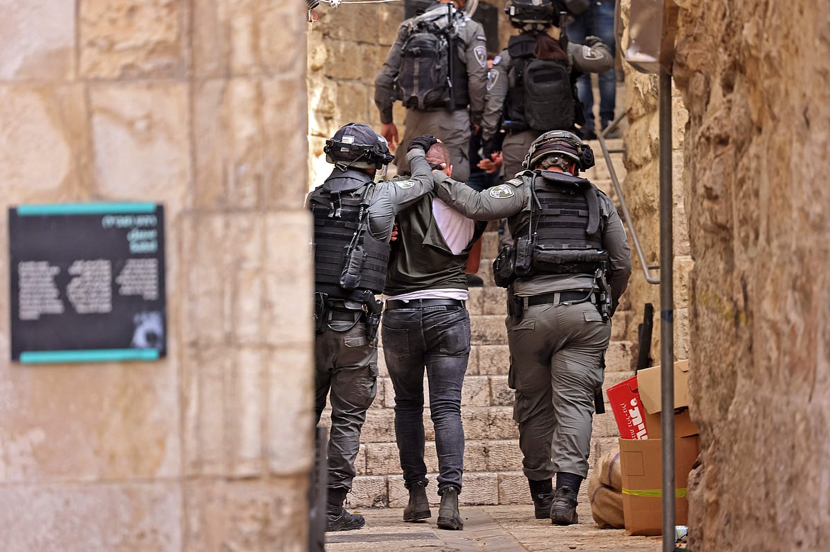 Israeli security forces detain a Palestinian protester amid clashes in Jerusalems Old City on May 10, 2021, ahead of a planned march to commemorate Israels takeover of Jerusalem in the 1967 Six-Day War.