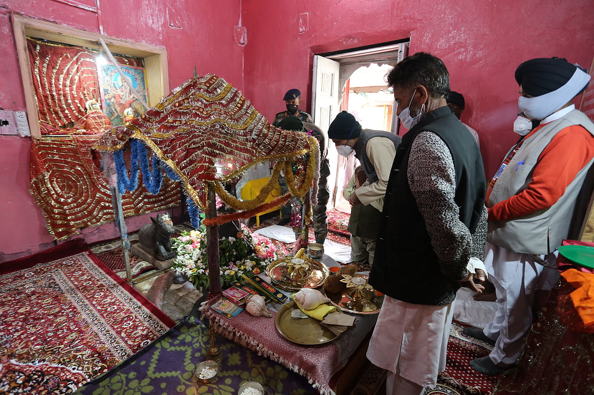 Officials pray at the hundred-year-old Shiv temple that was reopened for the public on June 01, 2021, after being renovated by the army battalion along with the locals in Gulmarg, Kashmir. 