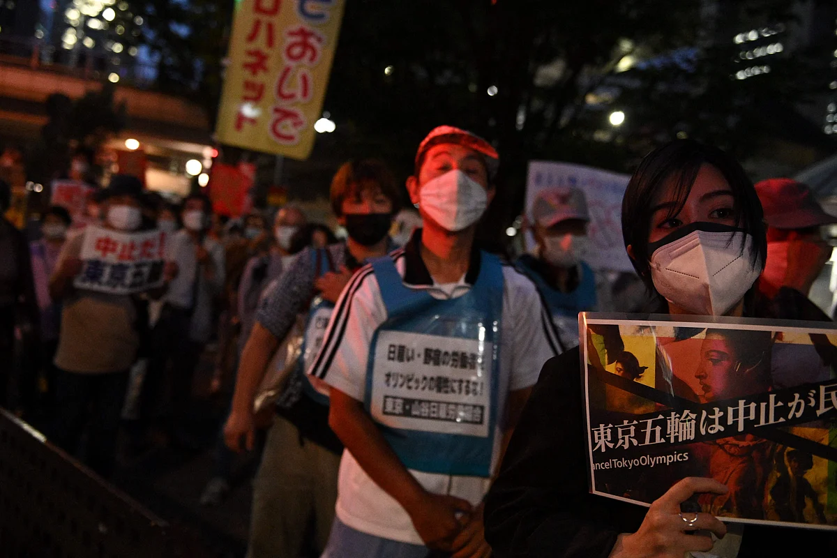 A group of anti-Olympic activists march from the metropolitan government building as they protest to mark the 30 days before the Olympic Games opening ceremonies, in Tokyo on June 23, 2021.