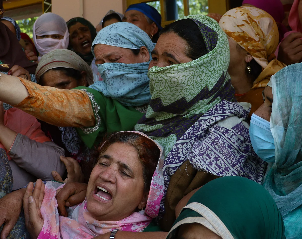 Relatives mourn the death of the daughter of Fayaz Ahmed, former SPO of Jammu & Kashmir Police. Ahmed, his wife, and daughter, were killed by suspected militants in Hariparigam village of Pulwama district in Kashmir on June 27, 2021.