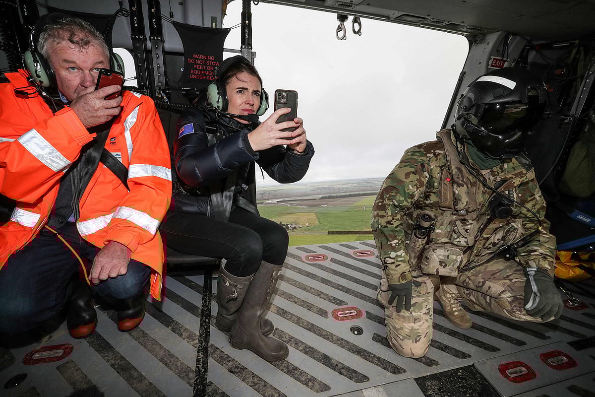New Zealands Prime Minister Jacinda Ardern (C) inspects the flood damage from an army helicopter on June 1, 2021 after heavy rains washed away bridges and cut roads in the Canterbury region.