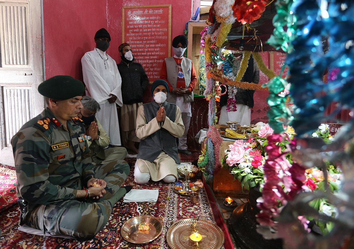 Officials pray at the hundred-year-old Shiv temple that was reopened for the public on June 01, 2021, after being renovated by the army battalion along with the locals in Gulmarg, Kashmir. 