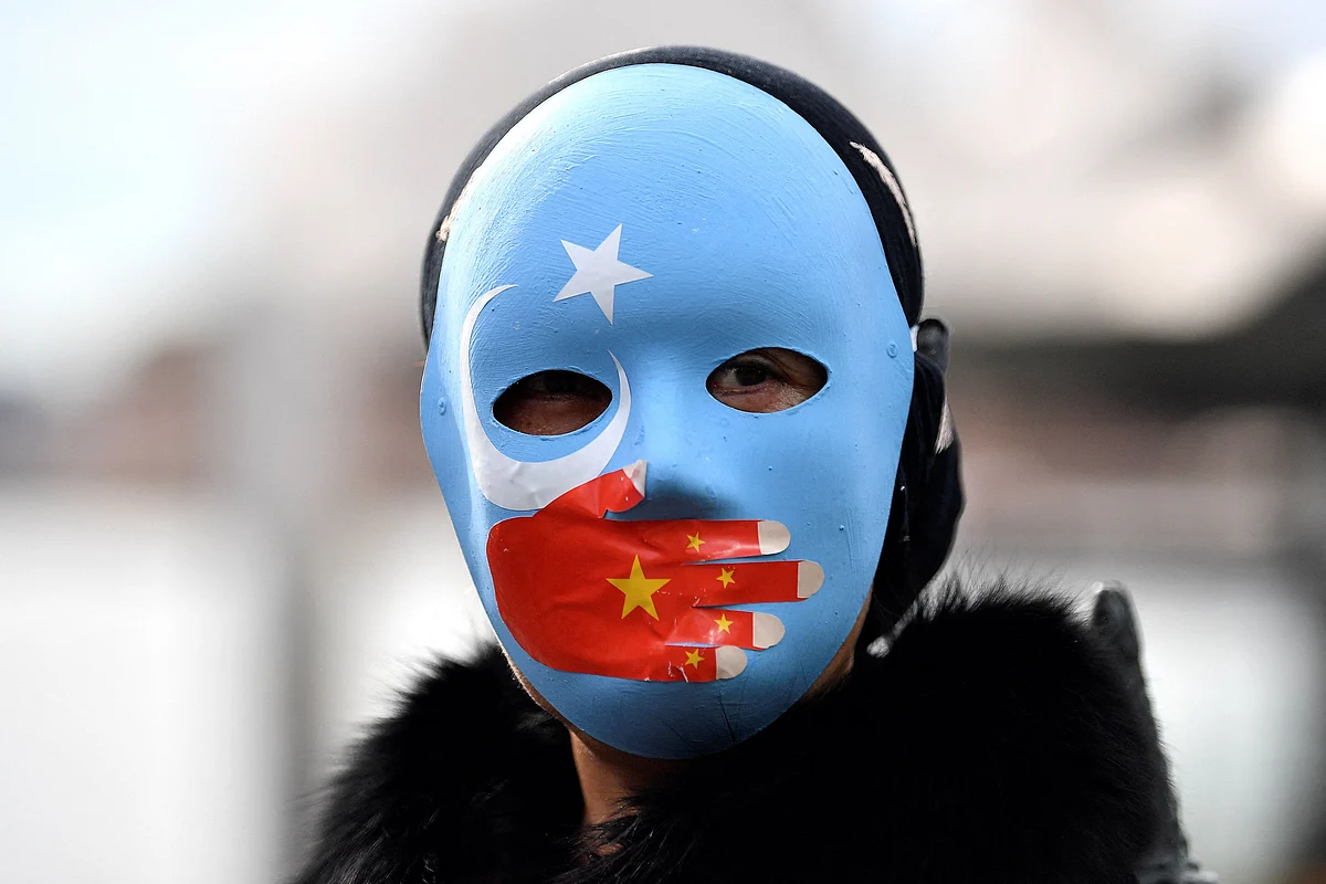 A protester wearing a face mask attends a demonstration in Sydney on June 23, 2021 to call on the Australian government to boycott the 2022 Beijing Winter Olympics over China's human rights record.