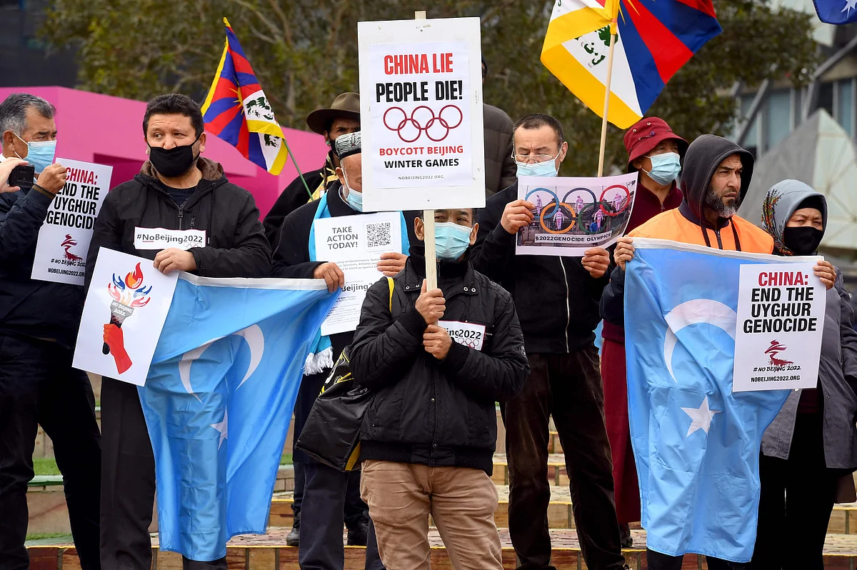 Activists including members of the local Hong Kong, Tibetan and Uyghur communities hold up banners and placards in Melbourne on June 23, 2021, calling on the Australian government to boycott the 2022 Beijing Winter Olympics over China's human rights record.