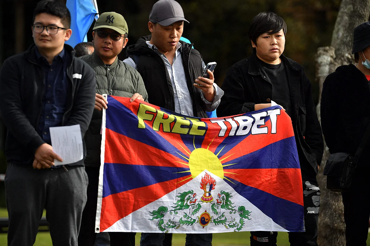 Protesters hold a banner as they attend a demonstration in Sydney on June 23, 2021 to call on the Australian government to boycott the 2022 Beijing Winter Olympics over China's human rights record.