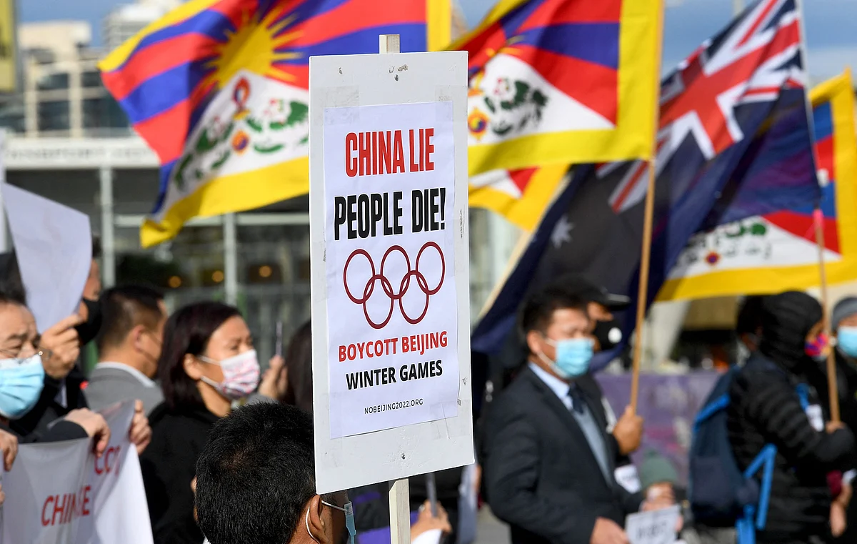 Activists including members of the local Hong Kong, Tibetan and Uyghur communities hold up banners and placards in Melbourne on June 23, 2021, calling on the Australian government to boycott the 2022 Beijing Winter Olympics over China's human rights record.