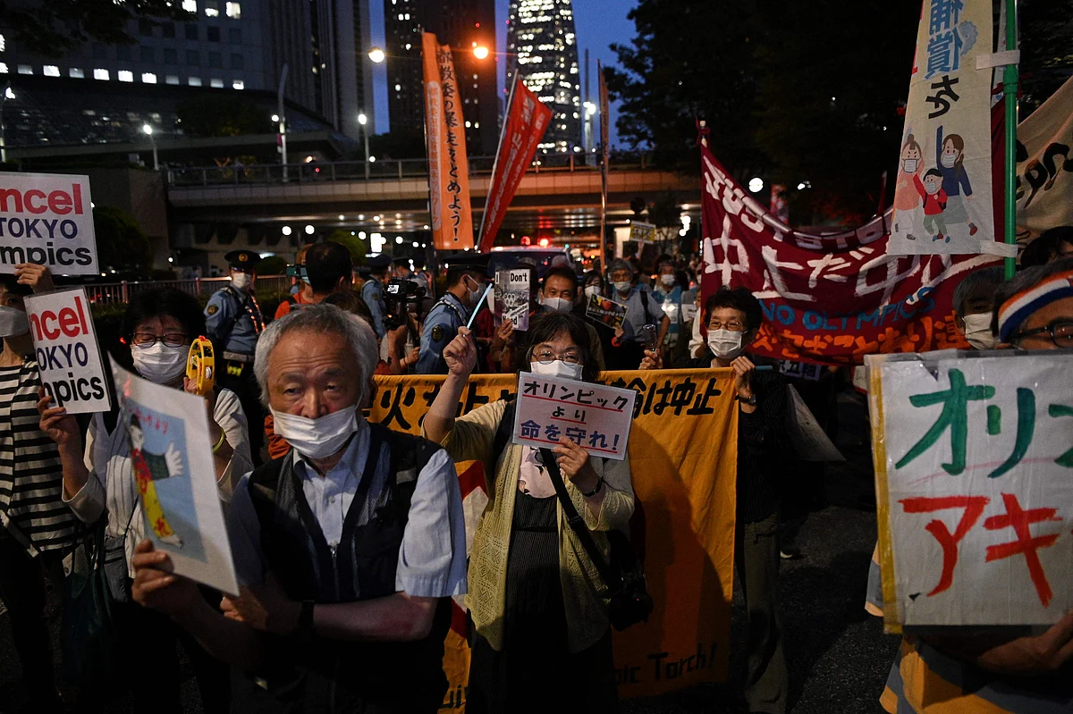 A group of anti-Olympic activists march from the metropolitan government building as they protest to mark the 30 days before the Olympic Games opening ceremonies, in Tokyo on June 23, 2021.