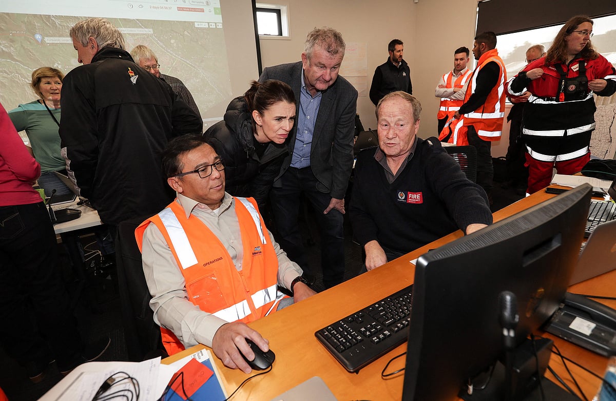 New Zealands Prime Minister Jacinda Ardern (2/L) visits the Emergency Operation Centre in Ashburton on June 1, 2021 as she inspects the flood damage after heavy rains washed away bridges and cut roads in the Canterbury region.