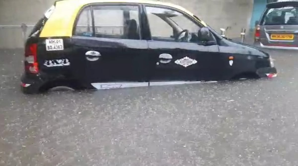 Taxi submerges into water at Hindmata, Lower Parel as heavy rainfall causes water-logging on Friday, July 16, 2021.