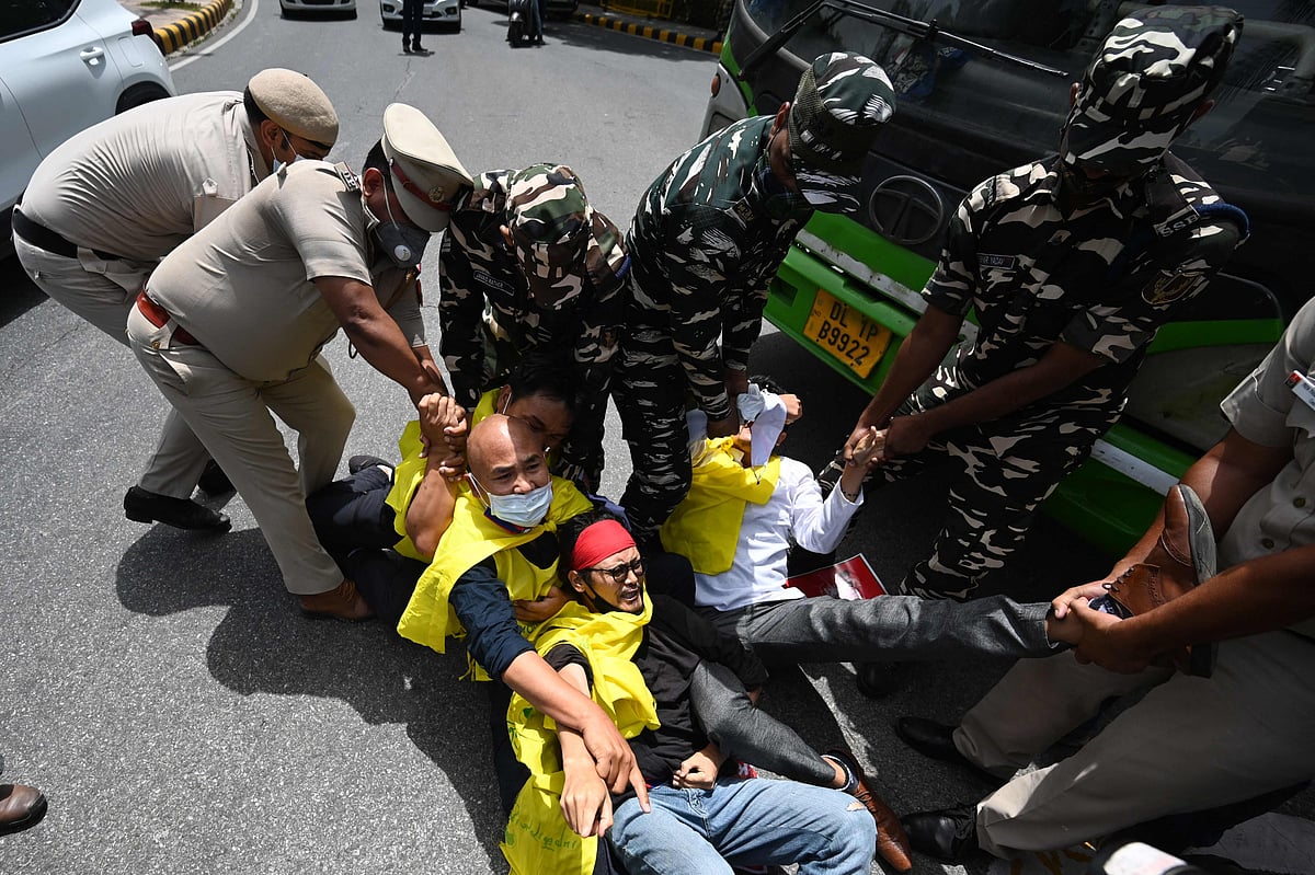 Activists of the Tibetan Youth Congress (TYC) international non-governmental organization shout slogans as they are detained by police during a protest outside the China embassy on the occasion of the 100th anniversary of the founding of the Chinese Communist party, in New Delhi on July 1, 2021.