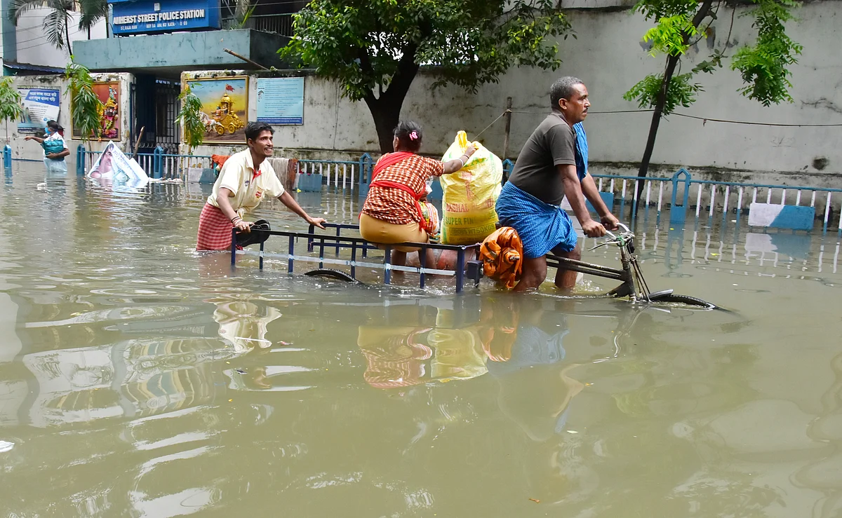 West Bengal, July 30 (ANI): People commute through waterlogged road after heavy rainfall, in Kolkata on Friday.