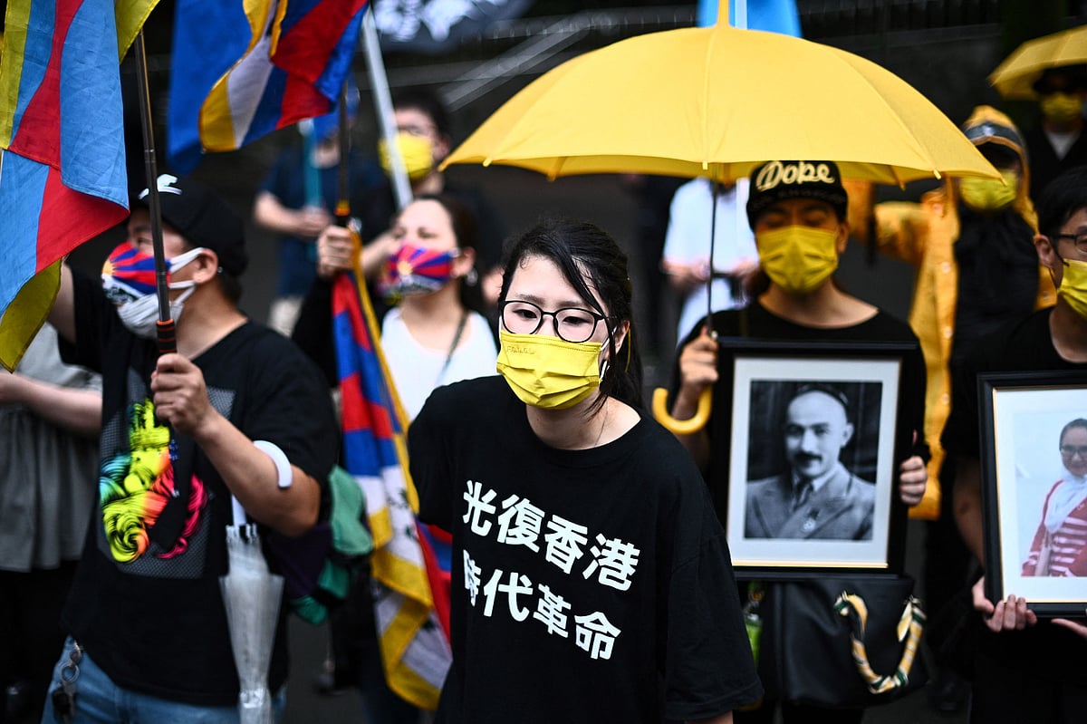 Pro-democracy activists chant slogans before a march to protest against the 100th anniversary of the founding of the Communist Party of China, in Tokyos Shinjuku district on July 1, 2021.
