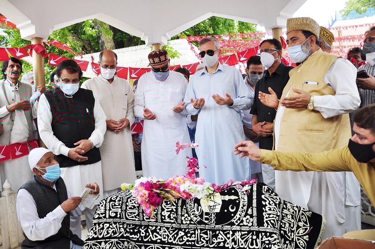 Jammu and Kashmir National Conference President and MP Dr. Farooq Abdullah, son Omar Abdullah, and senior party leaders pay tributes to Begum Akbar Jehan, ex-MP and wife of JKNC founder Sheikh Muhammad Abdullah on her 21st death anniversary at her grave Hazratbal in Srinagar on Sunday, July 11,2021