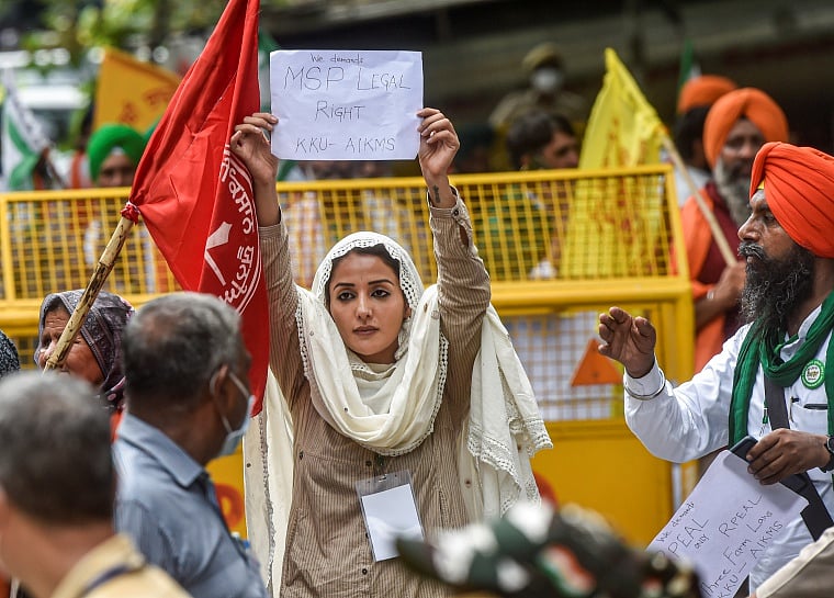 Actress Sonia Mann along with farmers hold placards at Kisan Sansad during a protest against the three farm laws at Jantar Mantar, in New Delhi on Thursday.