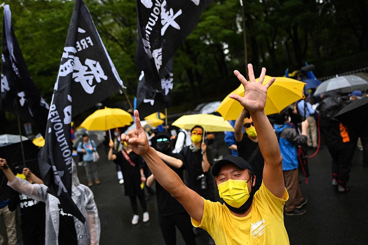 Pro-democracy activists chant slogans before a march to protest against the 100th anniversary of the founding of the Communist Party of China, in Tokyos Shinjuku district on July 1, 2021.