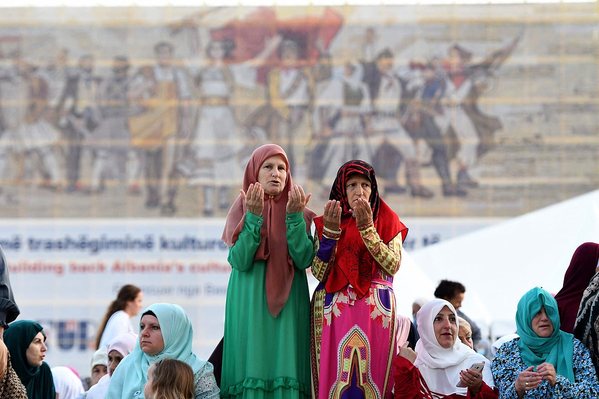 Albanian Muslim women pray during the Eid Al-Adha prayer at Skenderbej Square in Tirana on July 20, 2021.